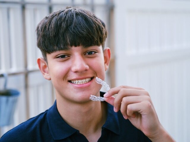 Teenager with clear aligners